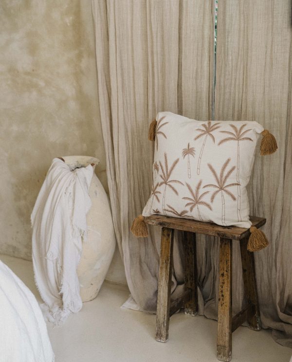Premium cushion cover in linen with embroidered palm trees and pom poms